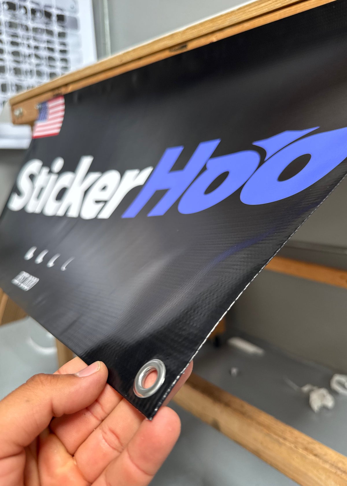 Person Holding Grommet corner of a Vinyl Banner branded StickerHoo 